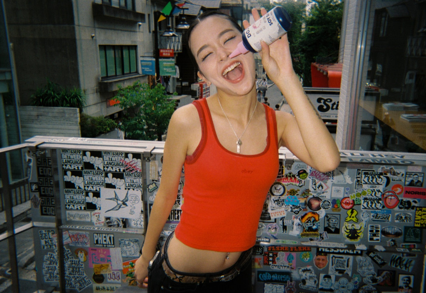 A new fan laughing with the Dojo bottle on a Tokyo street