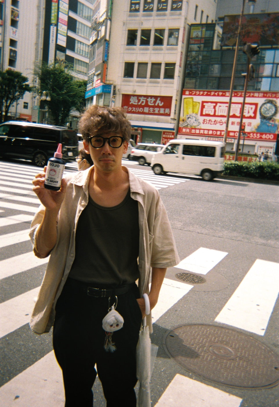 Crossing a Shinjuku intersection with the bottle in hand